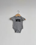 Grey baby onesie with 'MINI' print on a hanger against a white background, mini, matching, baby, baby jumper, onesie, cute