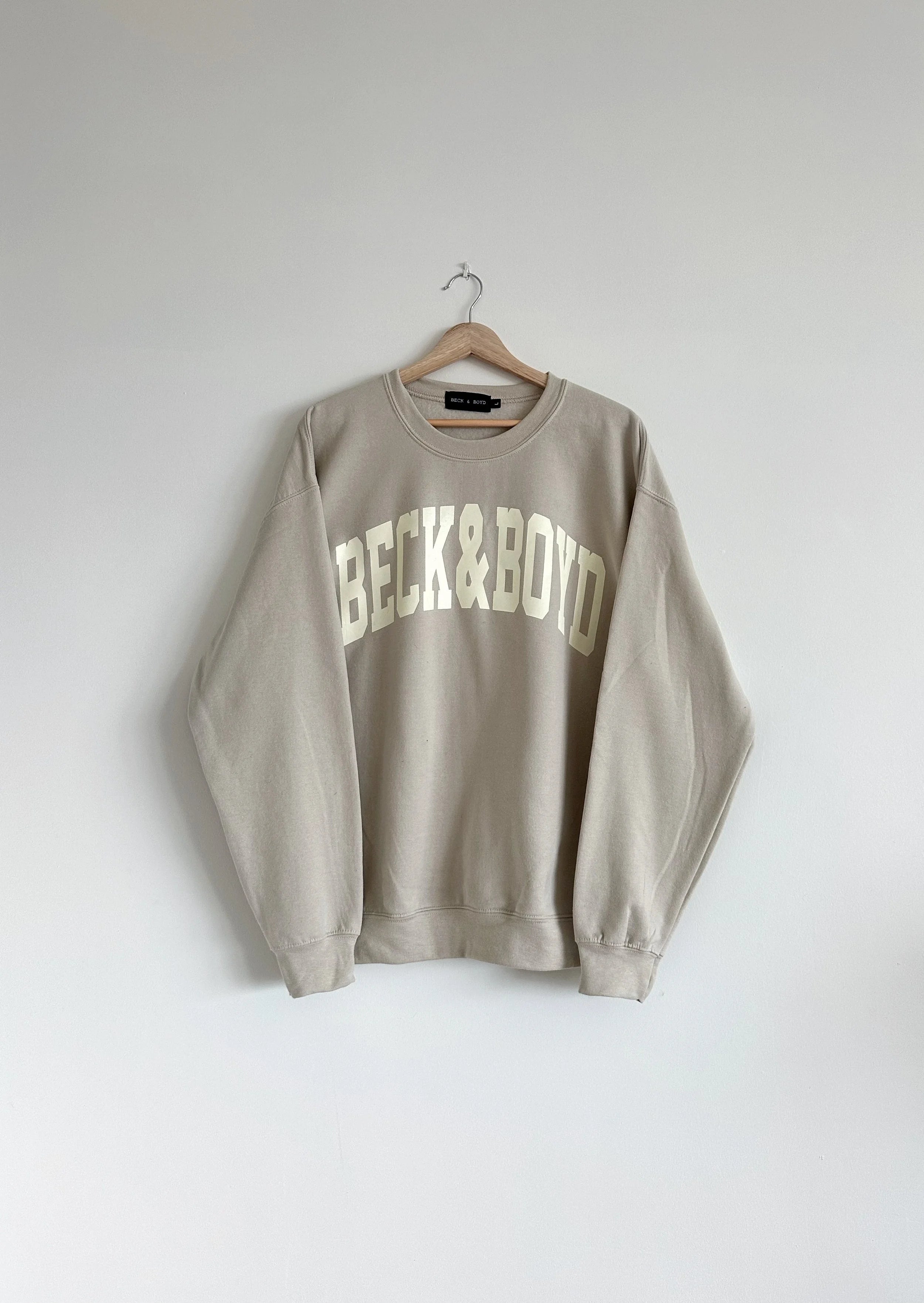 Beige sweatshirt with 'Beck & Boyd' text on a white background, Monochrome Sweater, Beige