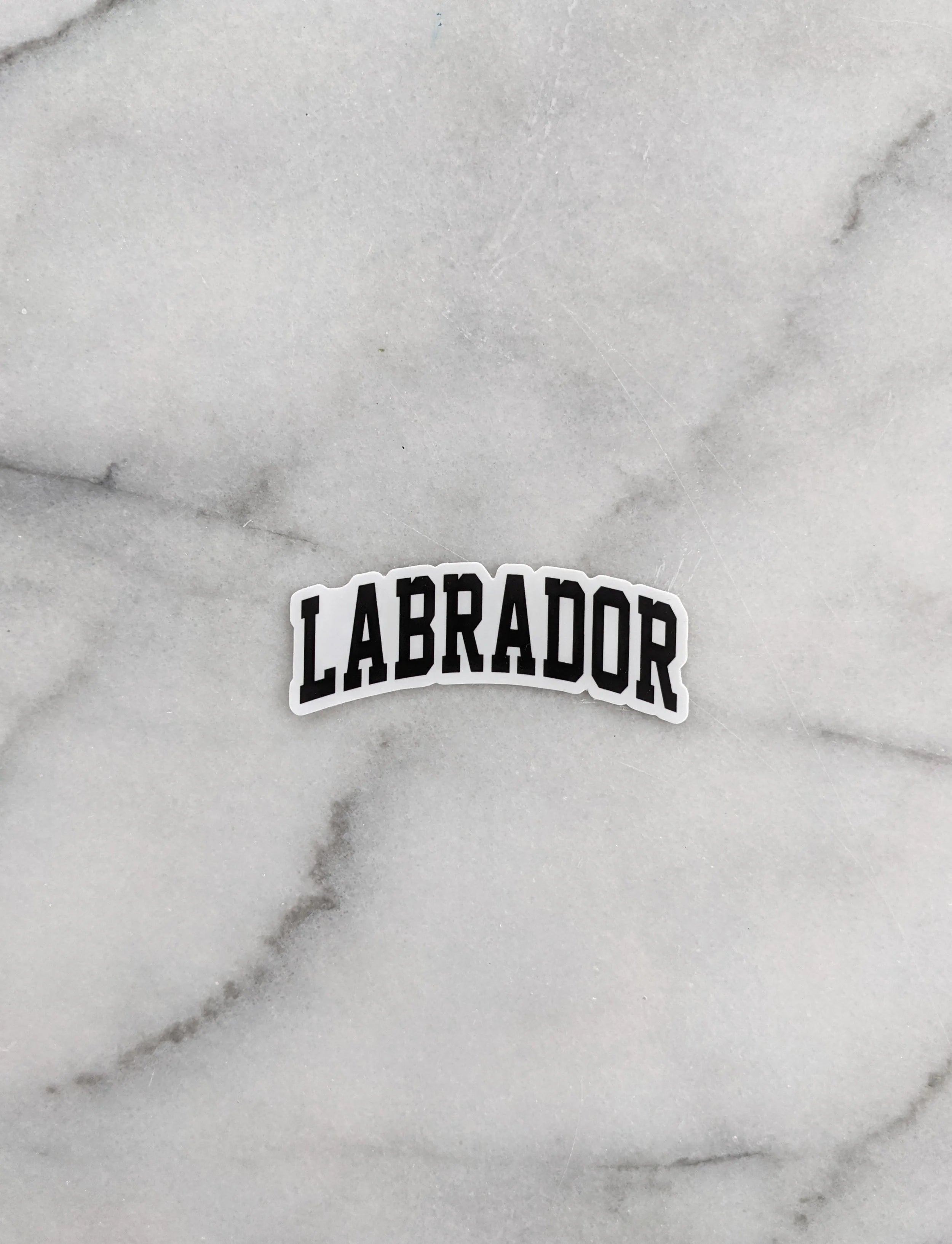 Sticker with 'LABRADOR' text on a marble background