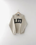 Beige sweatshirt with 'LEO' text on a white background, zodiac, gift ideas, astrology, lion