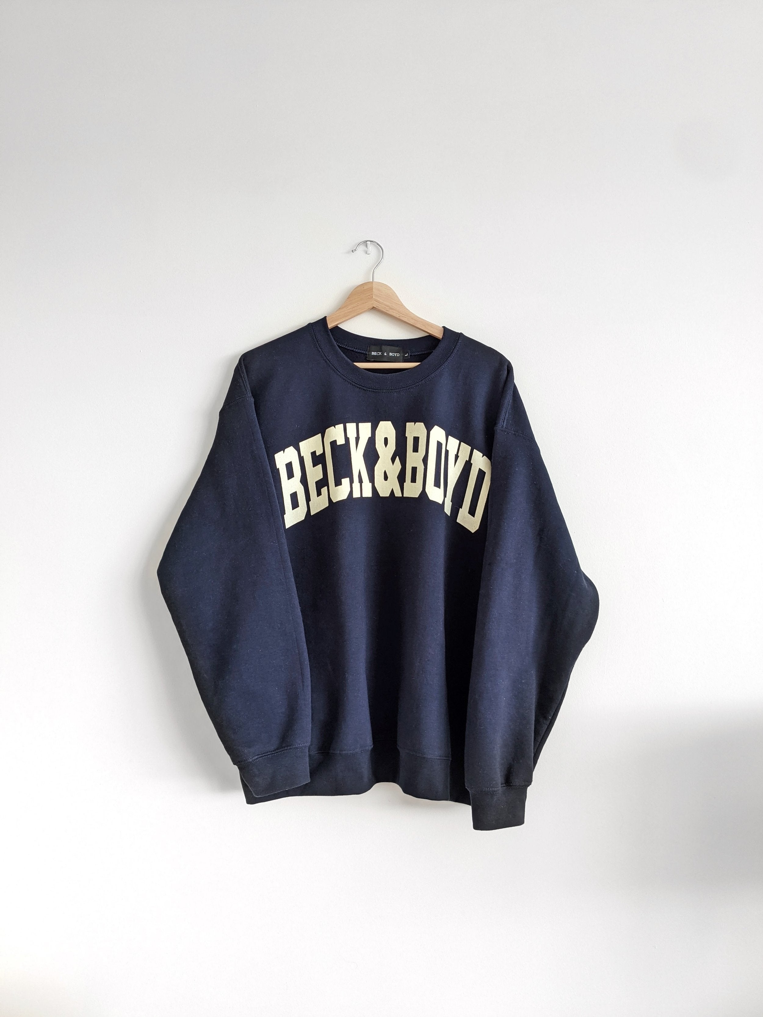 Navy blue sweatshirt with 'Beck & Boyd' text on a white background, cozy, gift ideas, navy blue, navy, comfortable