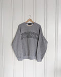 Grey sweatshirt with 'New Brunswick' text on a hanger against a white wall, Embroidered, Cozy, New Brunswick, NB, Maritimes, Gift Ideas