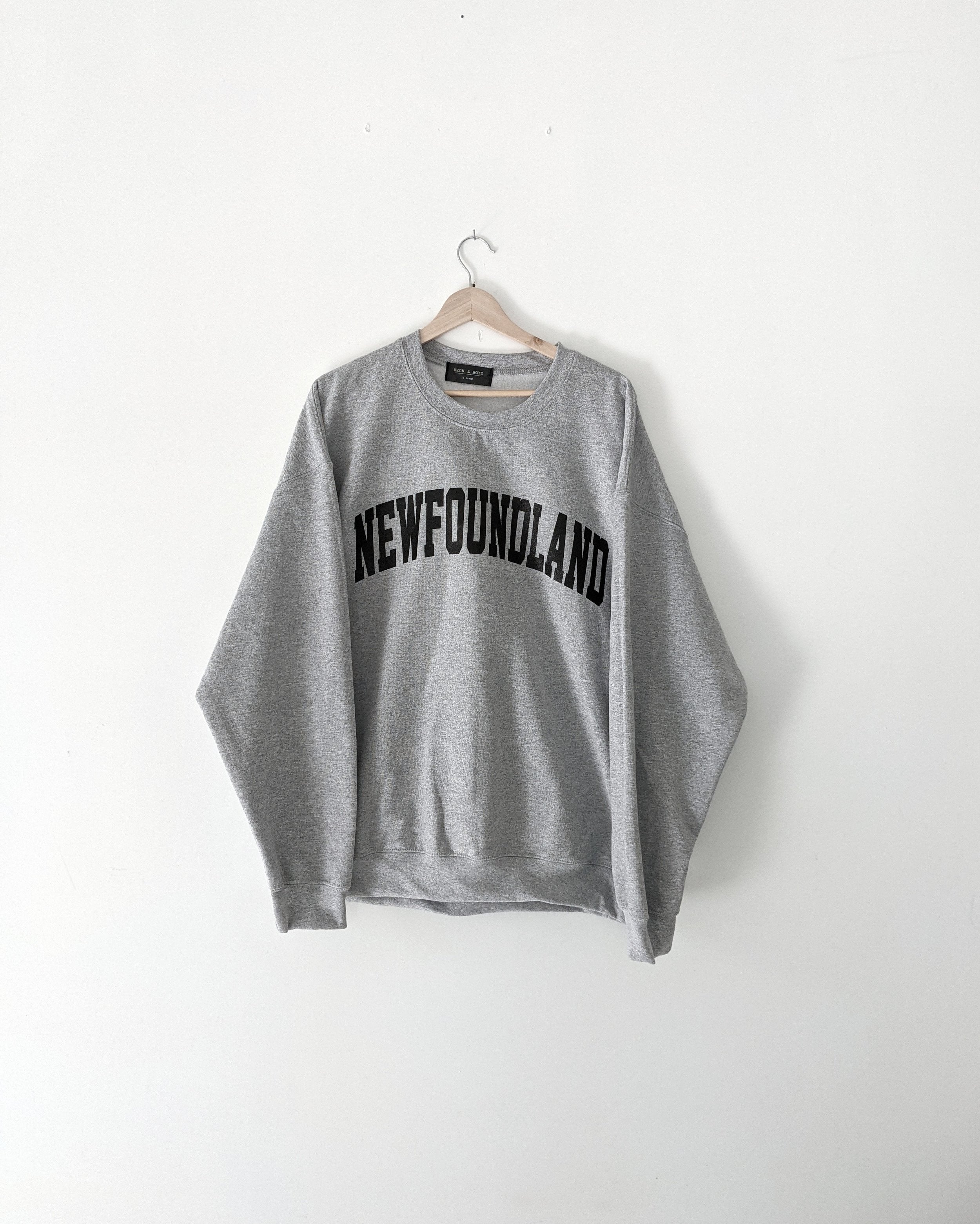 Grey sweatshirt with 'NEWFOUNDLAND' text on a white background,NFLD, Newfoundland, maritimes, Gift ideas, Cozy
