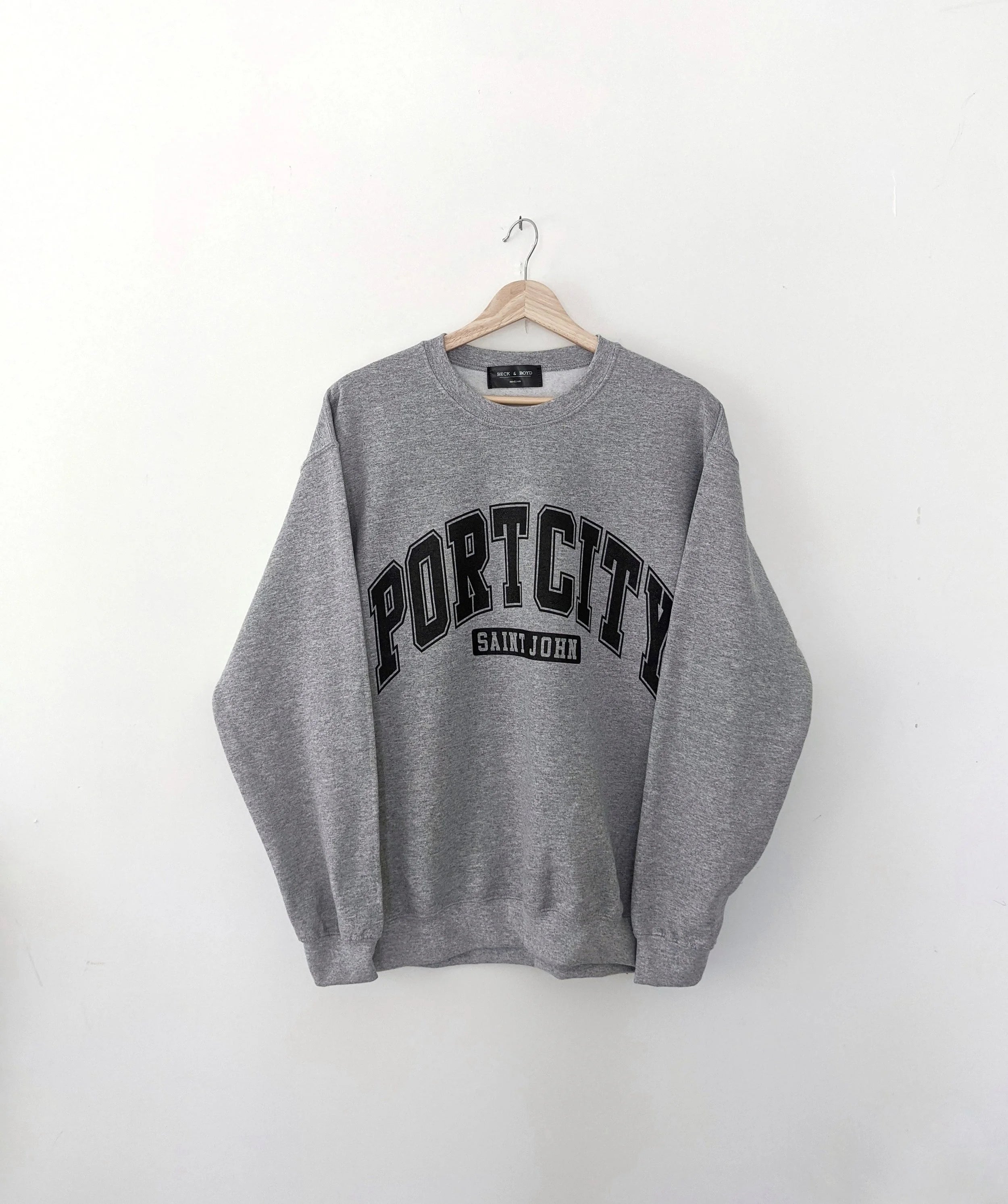 Grey sweatshirt with 'Port City Saint John' text on a white background, Saint John, New Brunswick, Tourism, Port City, Cozy sweater, Cozy