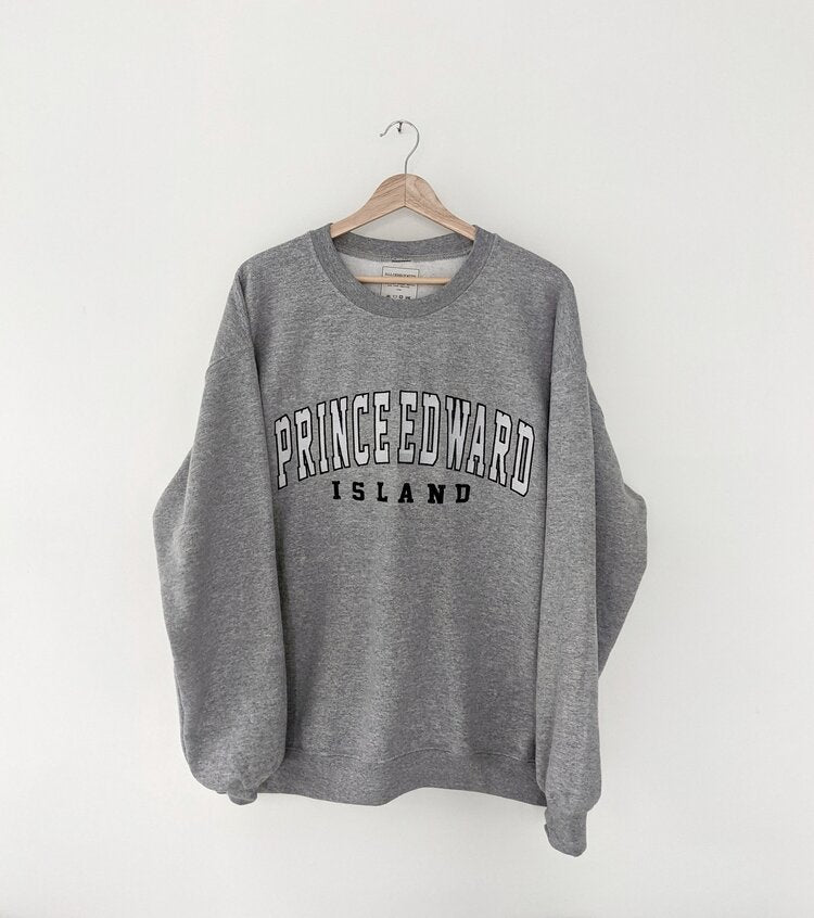 Grey sweatshirt with 'Prince Edward Island' text on a white background, embroidered style, cozy sweater, Prince Edward Island