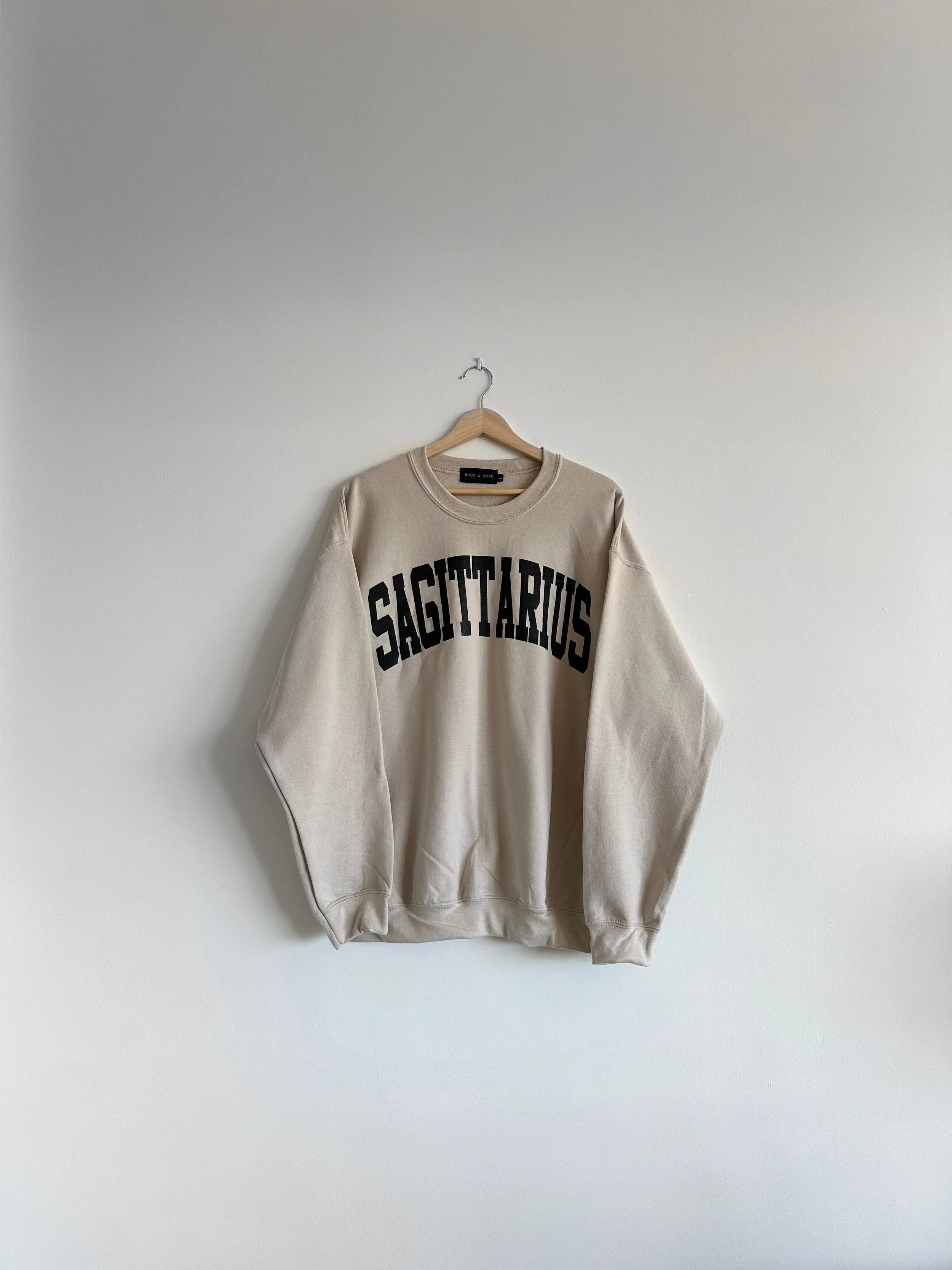 Beige sweatshirt with 'SAGITTARIUS' text on a white background, Sagittarius, Birthday, Birthday Gift, Zodiac, Astrology