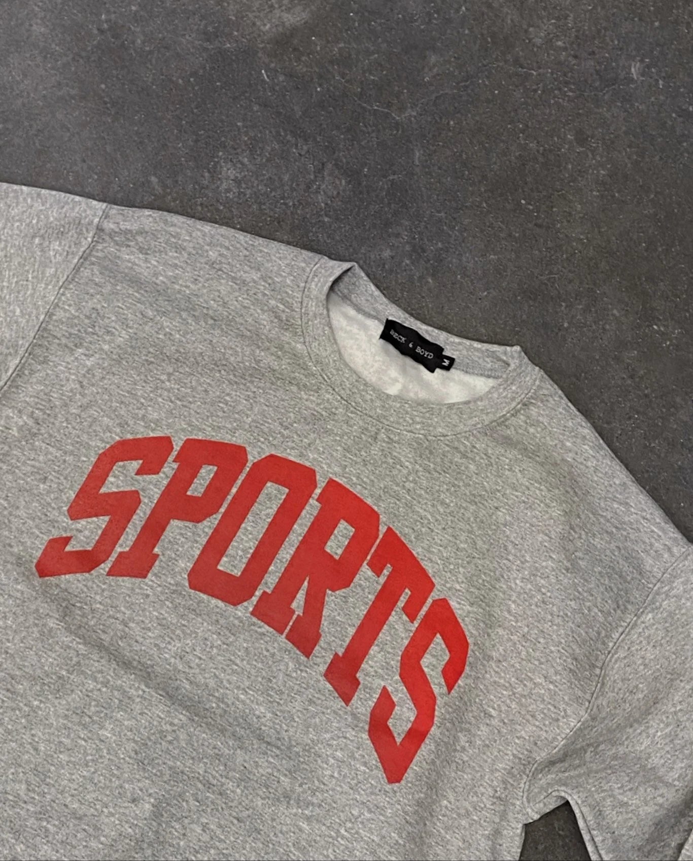 Grey sweatshirt with red 'SPORTS' text on a dark gray background, Sports, Montreal Canadiens, Hockey, Baseball, Sports merch, Sporty GF, Sports GF, Sporty Chic, Athletic